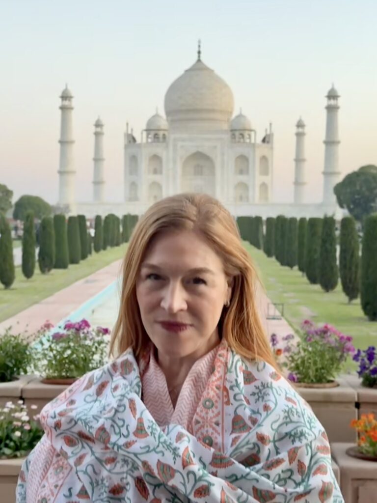 a woman in front of the Taj Mahal in India